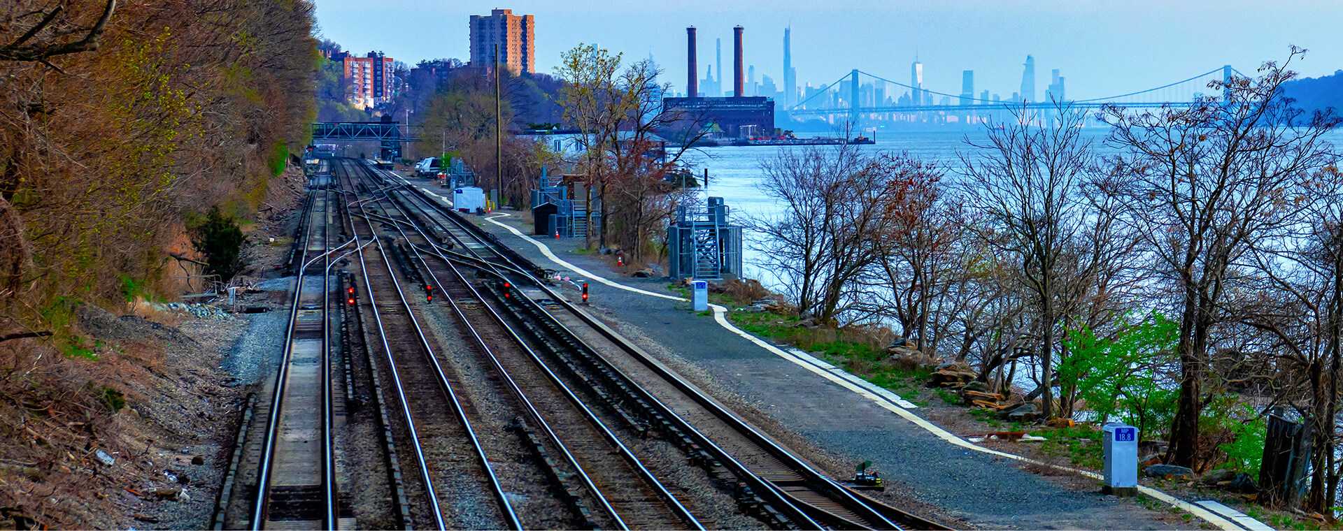 A train track by a river.