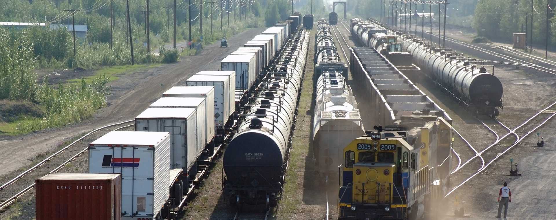 Multiple freight trains in a train yard.