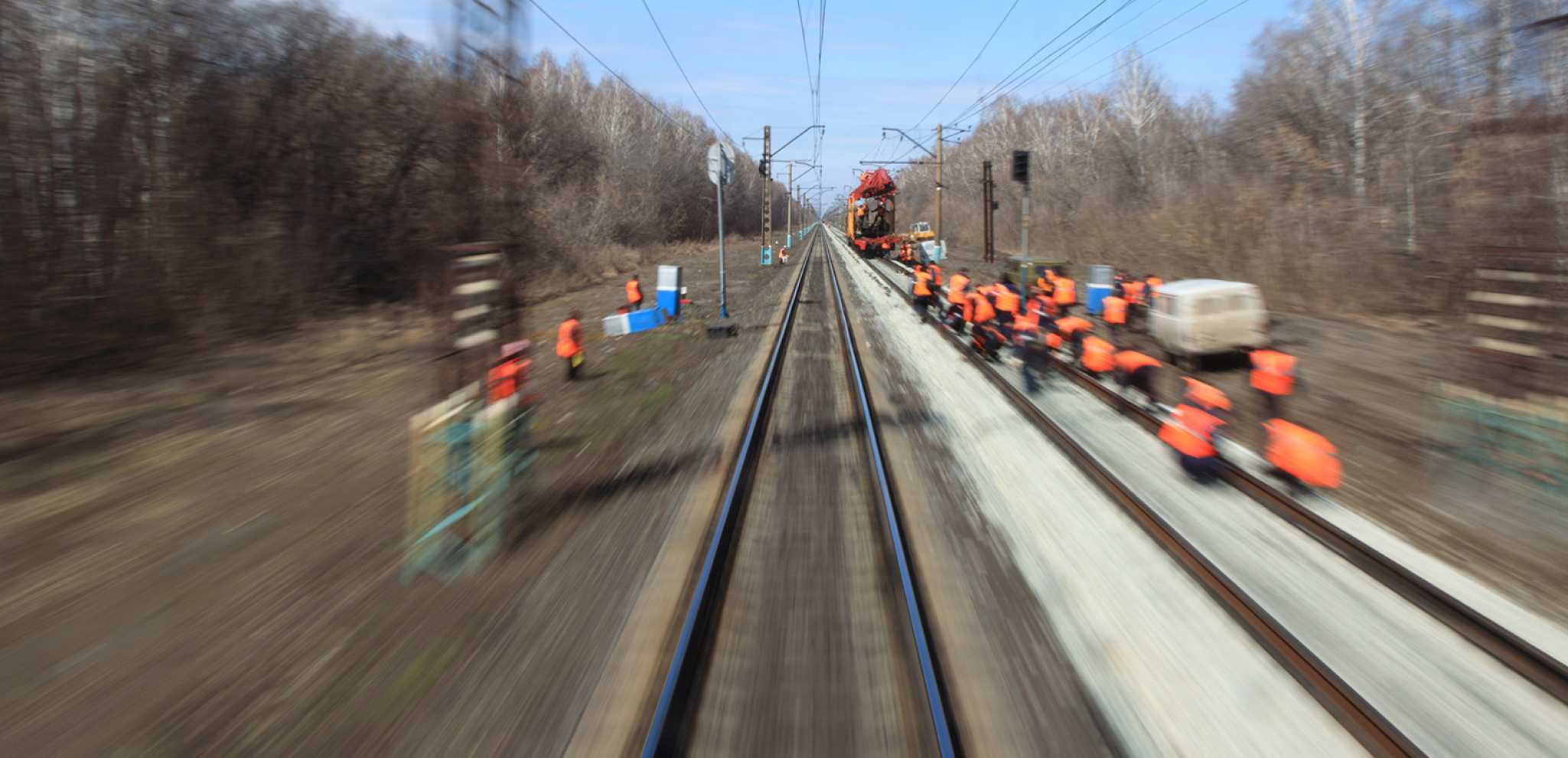 A team repairing a train track.