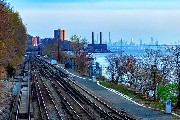 A train track by a river.