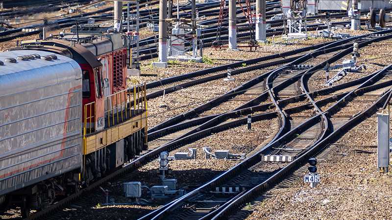 A train arriving at a switch on a train track.